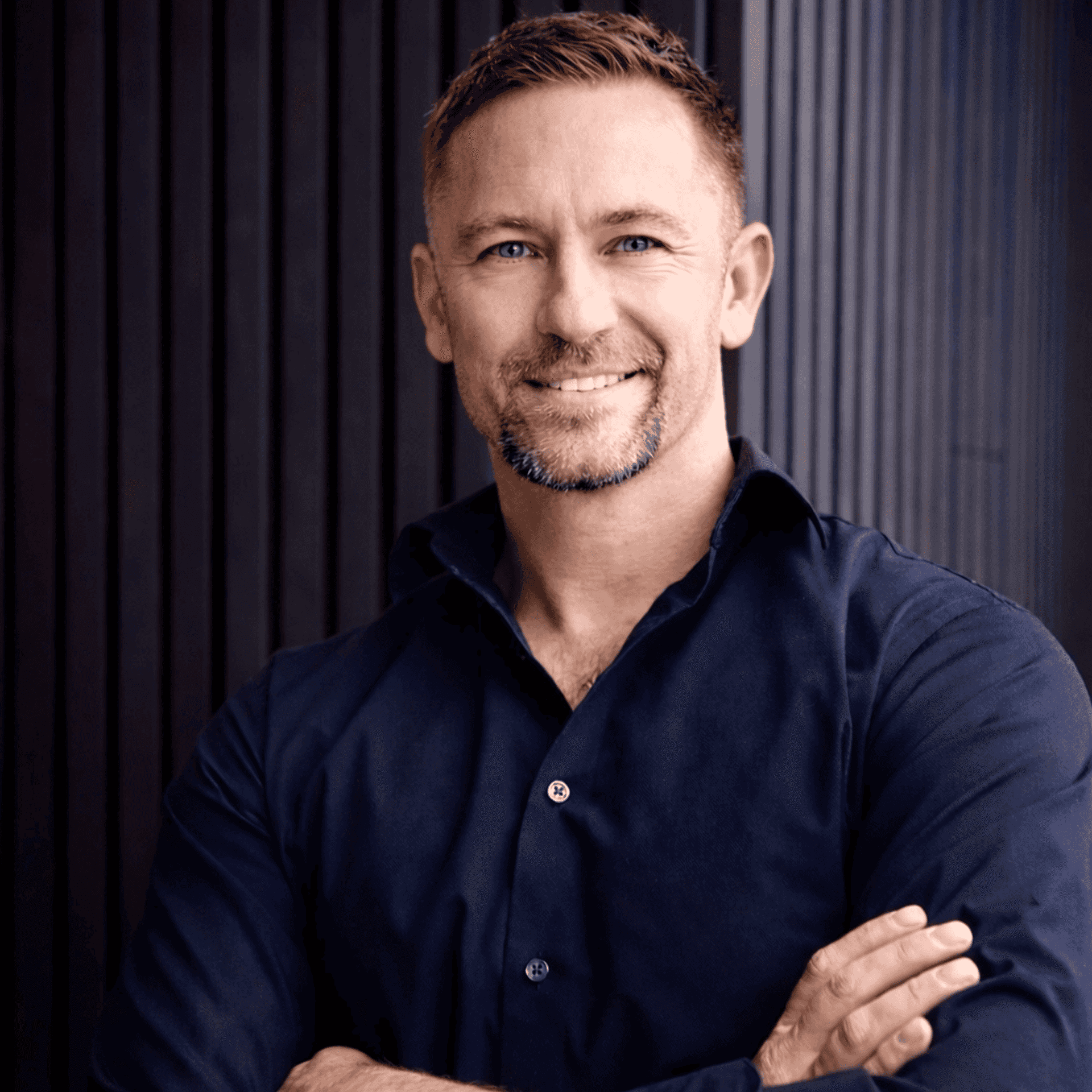 Portrait of Dan Burda, a professional stylist at Studio Raw Elite, showcasing their expertise and style.