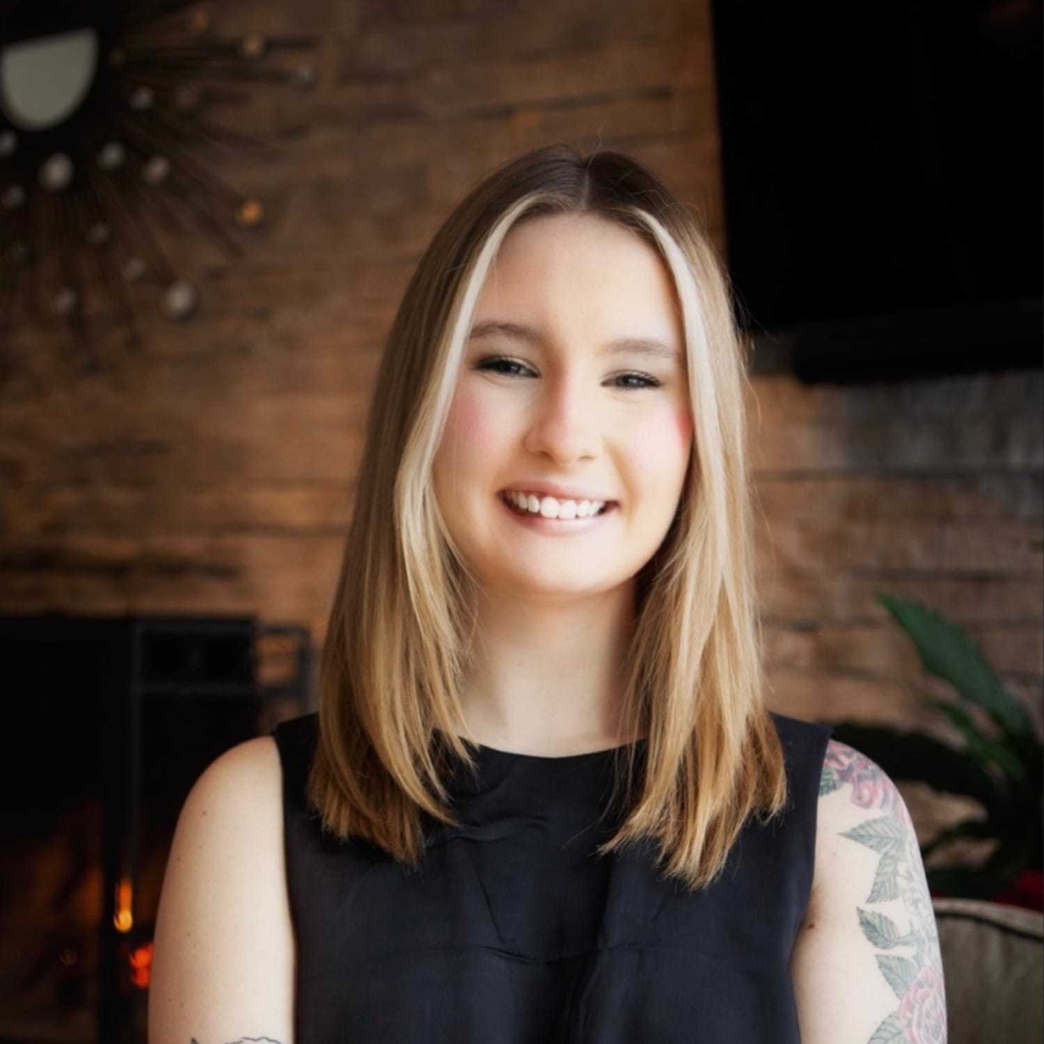 Portrait of Delaney MacAllister, a professional stylist at Studio Raw Elite, showcasing their expertise and style.