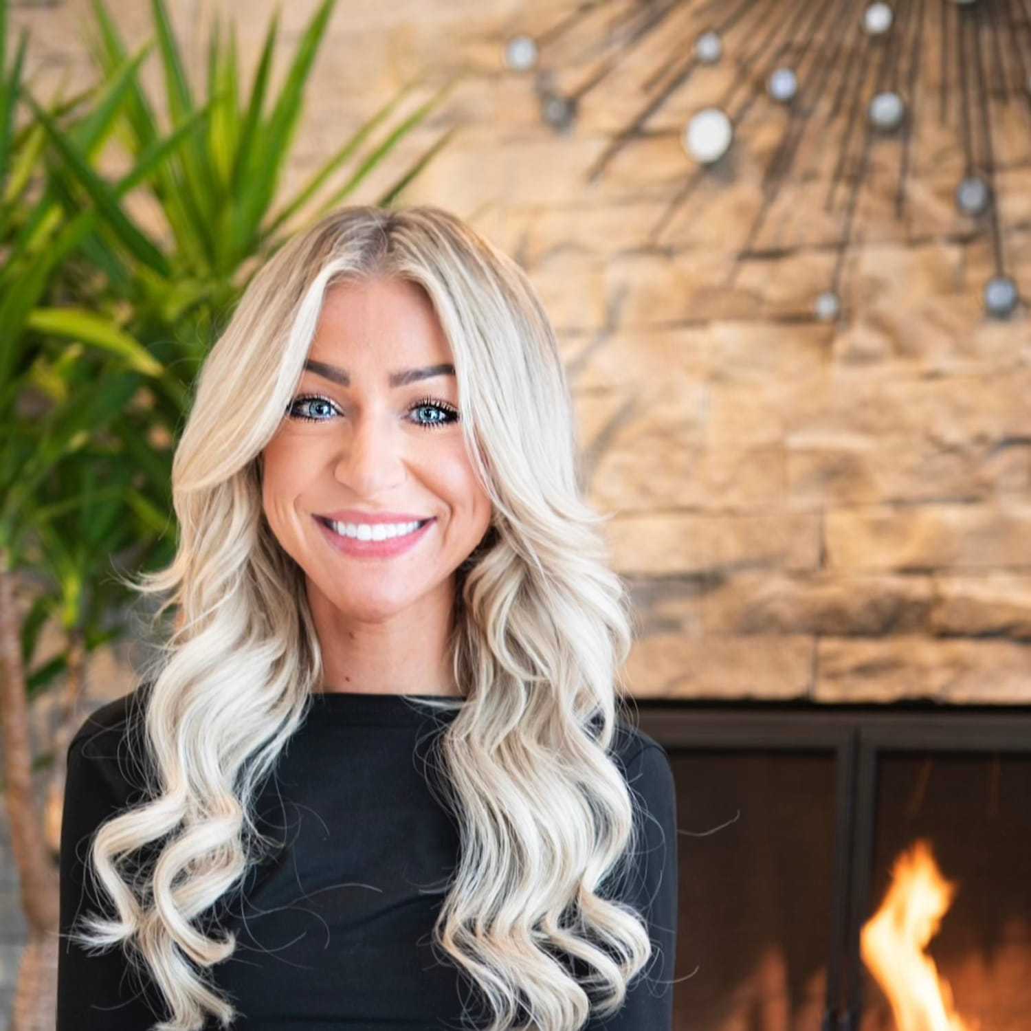 Portrait of Hannah Schrock, a professional stylist at Studio Raw Elite, showcasing their expertise and style.